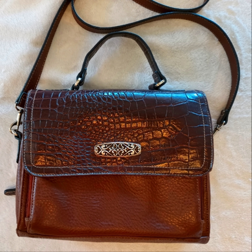Crossbody, shoulder bag.  Faux leather with silver tone embellishment.
